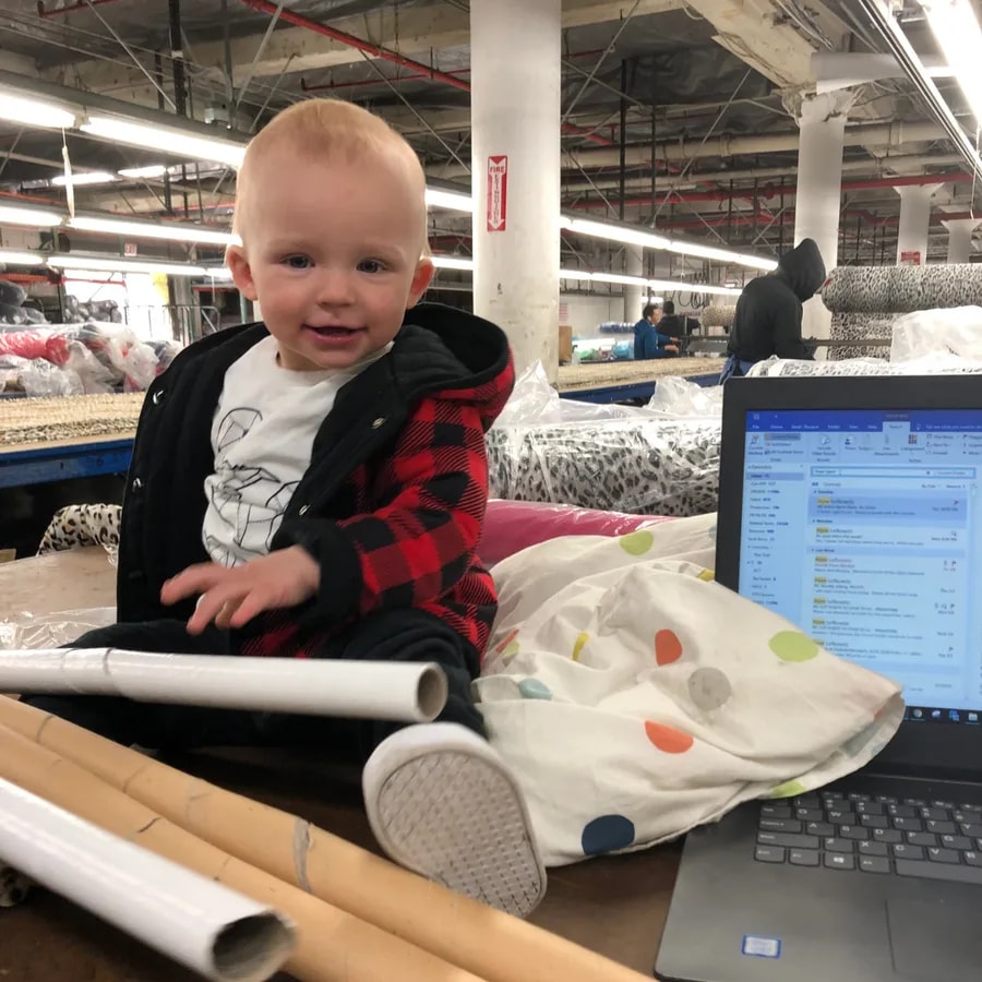 A baby visiting the garment workroom