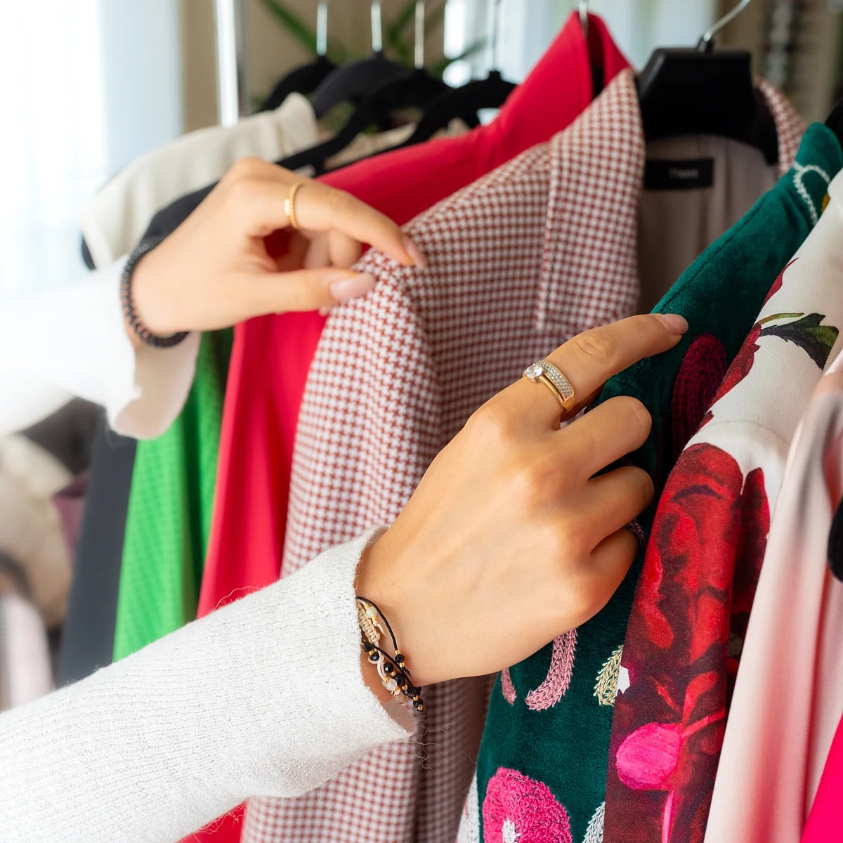 Personal stylist reviewing colorful garments on a wardrobe rack in White Plains, NY